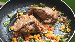 Add the ground beef to the sauteed vegetables