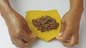 Scoop the filling over the flattened dough and fold over