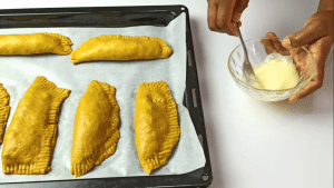Glaze the surfaces of the beef patties with egg wash