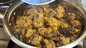 Now, bring in the marinated goat meat and sear for 10 minutes. Cover the pot and allow the meat to cook