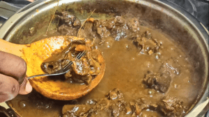 After an hour of cooking the curried goat, the meat should fall off easily from the bones.