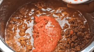 Add tomato sauce to the chili