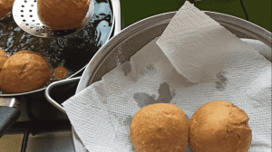 Drain the fried dumplings on paper towel