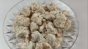 Place coated chicken pieces on a plate