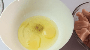 Season the eggs with black pepper and salt