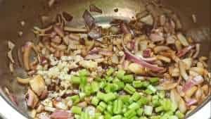 Add the celery sticks and minced garlic cloves