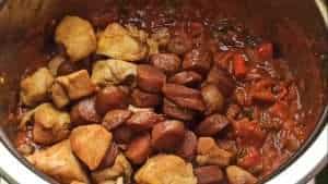 Add the fried chicken together with the sausages into the pot