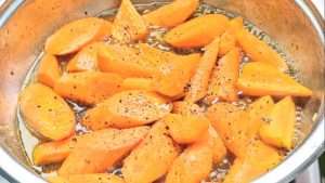 Season the roasted carrots with ground black pepper and salt