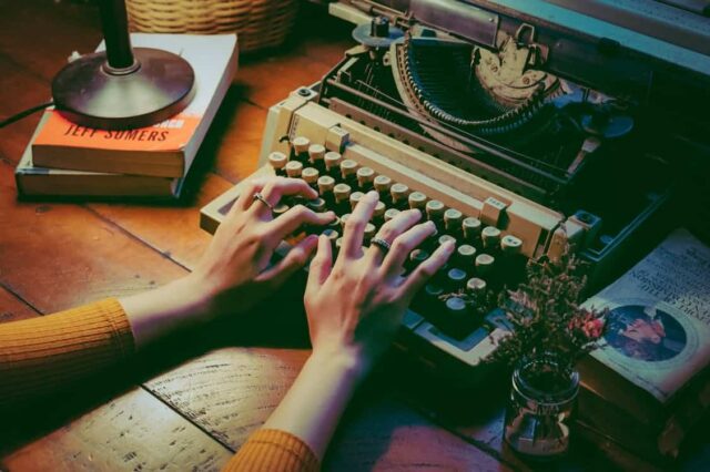 Free Person Using Typewriter Stock Photo